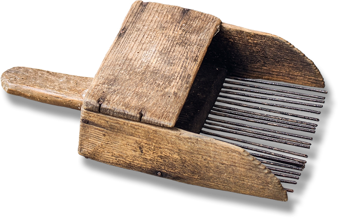 A rustic wooden handheld wild blueberry picker.